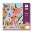 Colorful art kit featuring a fox design by Tara Lilly. The kit includes containers of colored sand in various shades, ideal for creating vibrant artwork. The packaging showcases a playful illustration of a fox surrounded by flowers and foliage, perfect for children aged 5-8.