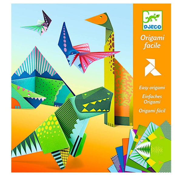 Dinosaur Origami DIY kit by DJECO featuring colorful origami papers and instructions. The kit displays vibrant origami dinosaurs, such as a T-Rex and pterodactyl, along with pyramids and mountains to create a fun prehistoric scene.