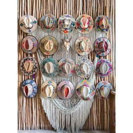 A colorful display of traditional Mexican hats arranged on a wooden wall. The hats showcase intricate patterns and vibrant designs, celebrating Mexican artistry.