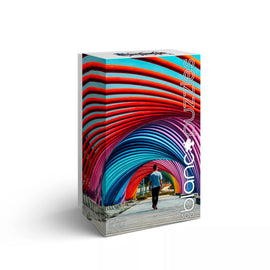 Blanc Puzzles Kuala Lumpur jigsaw puzzle box, featuring a vibrant design with multicolored arches and a person walking beneath them. The box displays a captivating image of Kuala Lumpur's colorful architecture, perfect for puzzle enthusiasts.