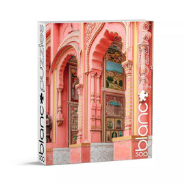 Blanc Puzzles Hawa Mahal jigsaw puzzle featuring an intricate design inspired by the iconic pink architecture of the Hawa Mahal palace in Jaipur, India. The box showcases colorful details of arches and artwork, perfect for puzzle enthusiasts and lovers of cultural landmarks. This 500-piece puzzle is great for family fun or solo challenges.