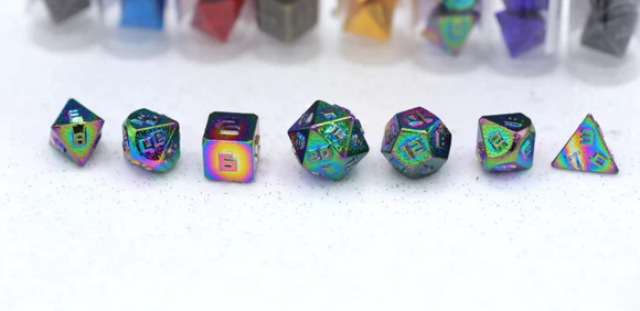 A vibrant 10MM Metal Rainbow RPG Dice Set by Hymgho, featuring a variety of geometric shapes including a d20, d12, and d6, showcased against a subtle glittery background. The dice exhibit a stunning rainbow metallic finish with clear and bold numbering.