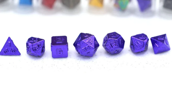 A set of six 10MM metal purple RPG dice displayed on a white surface. The set includes various shapes such as a pyramid, cube, and polyhedra, all featuring engraved numbers and a shiny finish. The background slightly blurs other dice in different colors, emphasizing the purple ones in the foreground.