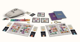 The Penny Black game by Buffalo Games features a vibrant assortment of colorful game components, including a canvas bag, wooden tokens, game cards, and a pair of game boards laid out for play. The game contains strategy elements and is designed for group interaction, appealing to both casual and experienced gamers.