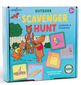 Eeboo's Outdoor Scavenger Hunt Game featuring a colorful box illustrated with playful bears engaging in a scavenger hunt. The image shows the game title prominently and highlights that it includes 50 cards and instructions, suitable for ages 3 and up. The background includes a green garden and a white fence, enhancing the outdoor theme.