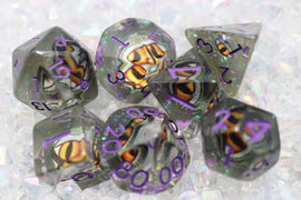 A stunning Venom Dragon Eye RPG Dice Set featuring seven polyhedral dice in shades of translucent gray and vivid orange accents. Each die displays intricate dragon eye imagery, complemented by vibrant purple numbers. Perfect for tabletop gaming and RPG enthusiasts, these dice add a unique flair to your gaming sessions.