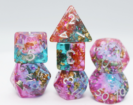 Scry Pool RPG Dice Set by Foam Brain featuring a colorful array of polyhedral dice. The set includes various shapes such as a d20, d12, d10, d8, d6, and d4, all with a vibrant mix of pink, blue, and gold glitter encased in transparent resin, ideal for tabletop gaming.