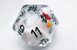 A 30mm Big Mama Hen D20 die, crafted by Foam Brain, featuring a playful design of a chicken inside a transparent polyhedral shape. The die has black numbers printed on its surfaces, adding a whimsical touch to gaming sessions.