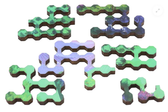 Canaa Valley Angela Gomes Jigsaw Puzzle pieces by Artifact Wooden Puzzles. Featuring uniquely shaped interlocking pieces in a vibrant green and purple color scheme, designed with intricate patterns reminiscent of verdant landscapes.