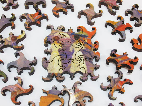 A collection of intricately designed wooden jigsaw puzzle pieces featuring vibrant colors and abstract patterns, with one piece prominently placed in the center. The artwork is inspired by the Cape Cod Pier, showcasing a beautiful blend of hues that create a stunning visual experience while assembling the puzzle.