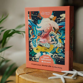 Impetuous World Life Velvet Puzzle by Trefl, featuring vibrant artwork of swirling ocean creatures including a fish and colorful motifs, comes in a soft-touch velvet box. The jigsaw puzzle includes 500 pieces and is designed by Rlon Wang, perfect for puzzle enthusiasts.