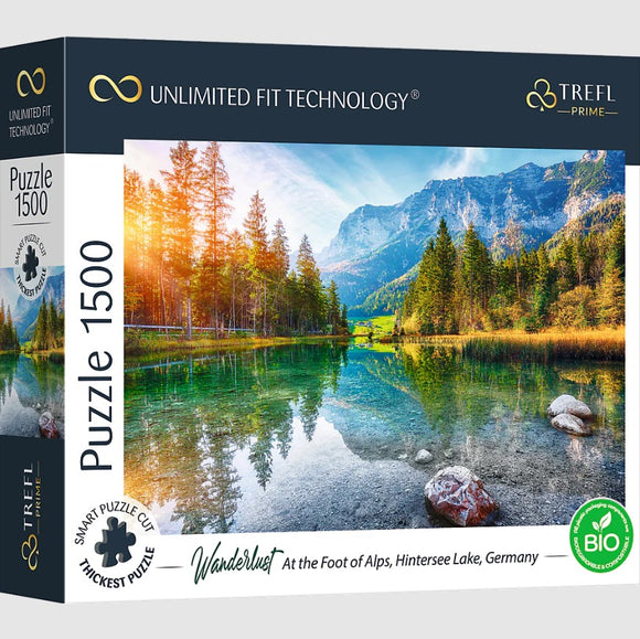 Wanderlust At the Foot of the Alps jigsaw puzzle featuring a stunning scene of Hintersee Lake in Germany, surrounded by majestic mountains and lush pine trees. This 1500-piece puzzle captures the vibrant colors of a serene landscape reflecting on the lake's surface, perfect for nature lovers and puzzle enthusiasts alike.