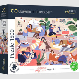 A colorful box of the Trefl Everyday Joy Hygge Life jigsaw puzzle featuring an illustration of people and pets enjoying cozy indoor moments. The scene depicts individuals relaxing on couches, playing with pets, and engaging in various leisurely activities in a vibrant, homely environment.