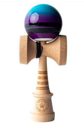 The Double Stripe Fade Blue Kendama features a beautifully crafted wooden handle with a distinctive striped pattern and a vibrant blue and purple fade ball. This high-quality kendama is perfect for skill development, play, and tricks, showcasing a unique design that's both eye-catching and functional.