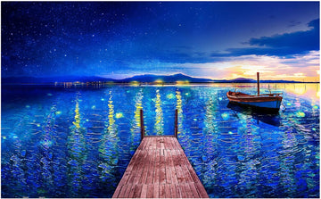 A beautifully illustrated jigsaw puzzle titled 'Fantasy Puzzle - Starry Night Port' by Pintoo, featuring a serene dock extending over a shimmering blue lake under a starry sky, with a small boat gently floating nearby. The vibrant colors depict the reflection of stars and lights on the water, creating a captivating scene perfect for puzzle enthusiasts.