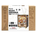 The Music Dreamer Sunset Carnival DIY kit by Robotime showcases a whimsical carnival scene with a ferris wheel and musical elements inside a retro-style television. The packaging features engaging graphics and a warning that the kit includes small parts, suitable for ages 14 and up.