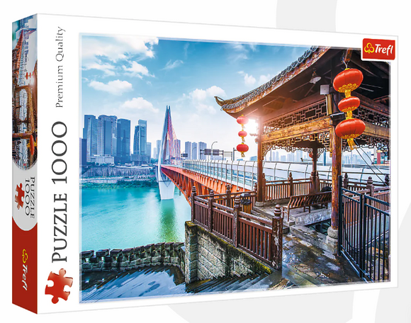 Trefl 1000-piece jigsaw puzzle featuring a stunning view of Chongqing, China, showcasing the city's bridge and skyline with a traditional pavilion in the foreground. The image captures vibrant colors and intricate details, making it a beautiful challenge for puzzle enthusiasts.