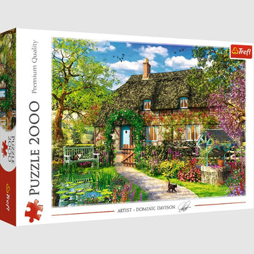 Trefl Country Cottage 2000 piece jigsaw puzzle featuring a beautifully illustrated scene of a quaint cottage surrounded by lush greenery and colorful flowers, set against a bright sky. The intricate details and vibrant colors make this puzzle a delightful challenge for puzzle enthusiasts.