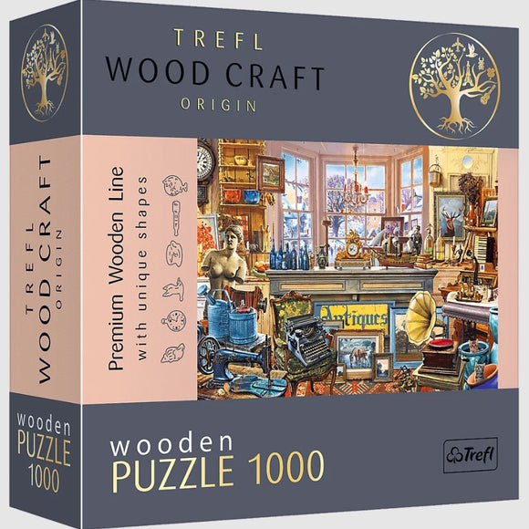 Trefl Antique Shop Wood Puzzle - a 1000-piece jigsaw puzzle featuring a vibrant image of an antique shop filled with various collectibles and curiosities. The packaging shows intricate details with unique shapes, inviting puzzle enthusiasts to explore the charming scene inside.