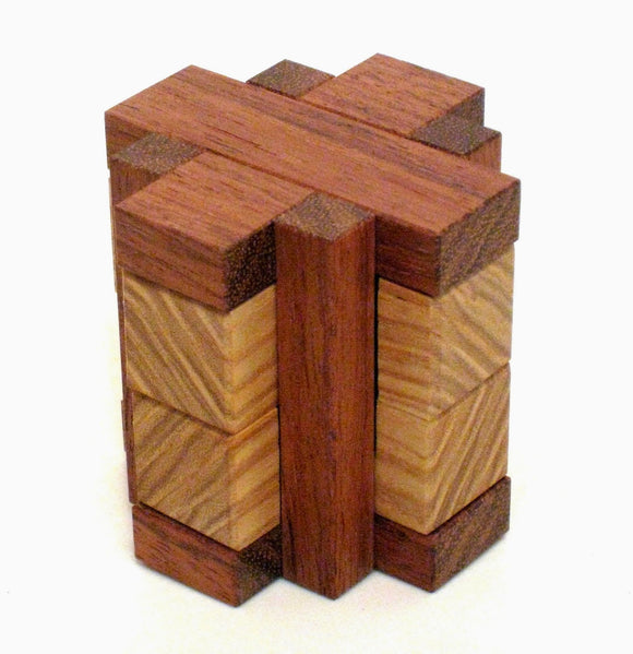 Ice Pillar by Pelikan Puzzles is a beautifully crafted mechanical puzzle made from various types of wood. It features intricately designed blocks that challenge the user to manipulate and solve the puzzle. The piece showcases a combination of warm and light wooden colors, providing a visually appealing and tactile experience. Perfect for puzzle enthusiasts and collectors alike.