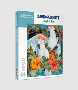 Tropical Trio jigsaw puzzle by David Galchutt, featuring vibrant artwork of three white cockatoos surrounded by colorful tropical flowers and foliage. The puzzle is 1000 pieces and comes in a decorative box with a preview of the artwork on the cover.