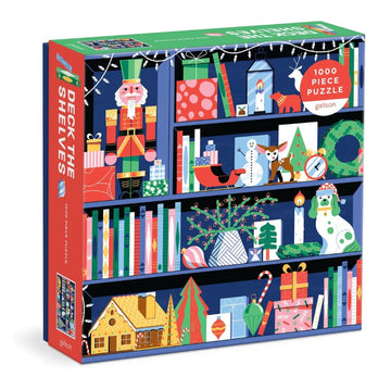 Deck the Shelves jigsaw puzzle by Galison, featuring a colorful illustration of a decorated bookshelf for the holiday season, including festive gifts, a nutcracker, and seasonal decor in a cozy design. Contains 1000 pieces for family fun.