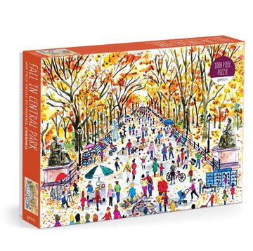 Michael Storrings Fall in Central Park jigsaw puzzle by Galison featuring a vibrant autumn scene in Central Park, with colorful trees, people walking, and activities in the park. The box displays a lively illustration capturing the essence of fall.