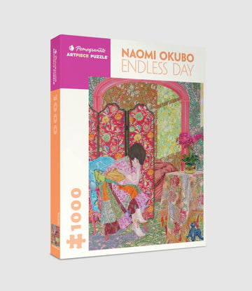 The Endless Day jigsaw puzzle by Pomegranate features a vibrant illustration by Naomi Okubo. The design shows a young girl in a colorful, patterned dress sitting in a richly decorated room. Behind her is a floral screen, and a table adorned with flowers and other decorative items, showcasing intricate details and vivid colors.