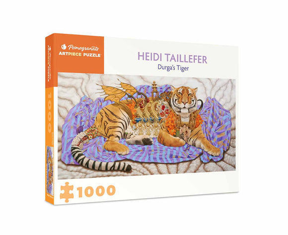 Durga's Tiger jigsaw puzzle by Pomegranate, featuring a beautifully illustrated tiger draped in colorful fabrics and surrounded by vivid decorations. The box includes 1000 pieces and showcases the artwork of Heidi Taillefer, making it perfect for art lovers and puzzle enthusiasts alike.