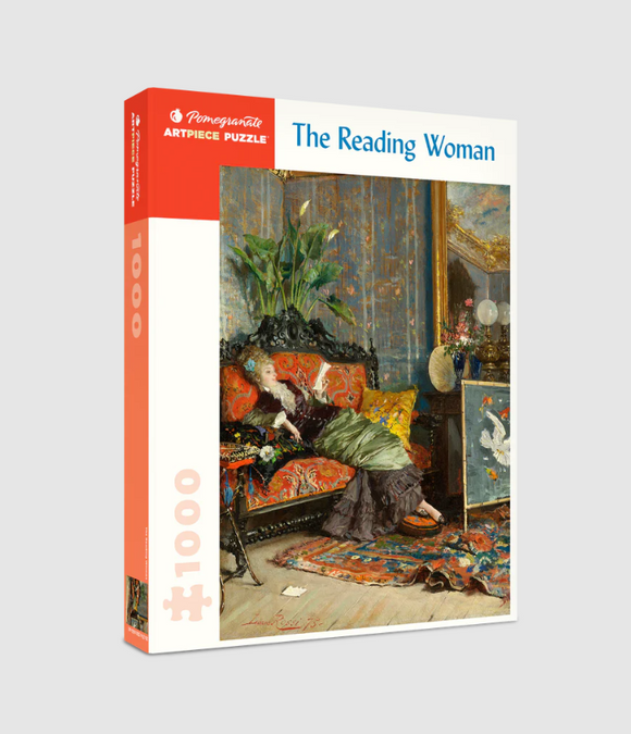 A 1000-piece jigsaw puzzle titled 'The Reading Woman' by Pomegranate featuring a classic scene of a woman lounging in a sumptuous room, absorbed in her book. The image showcases intricate details of the opulent furniture, decorative elements, and vibrant colors, making it an inviting and artistic puzzle for enthusiasts of art and reading.