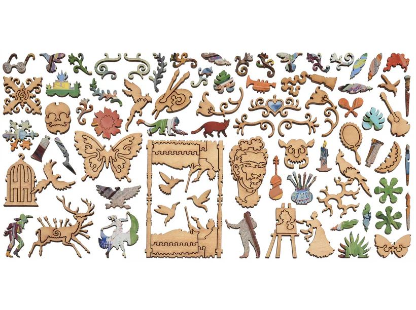 A colorful assortment of intricate wooden jigsaw puzzle pieces inspired by Frida Kahlo's studio. The pieces include decorative elements like butterflies, flowers, musical instruments, and figures, showcasing vibrant designs and artistic motifs that reflect Kahlo's creative spirit.