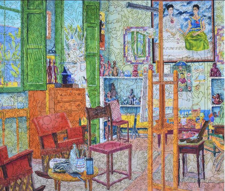 A colorful jigsaw puzzle depicting Frida Kahlo's studio, featuring vibrant greens and yellows, eclectic furniture, art supplies, and elements that echo Kahlo's artistic spirit.