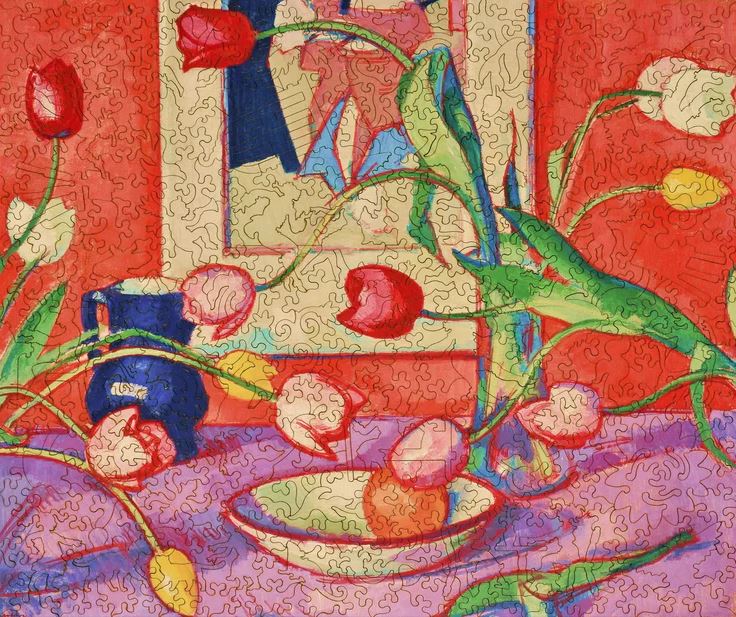 A colorful jigsaw puzzle featuring an artistic representation of tulips arranged in a blue jug against a vibrant red background. The puzzle showcases detailed colors of the flowers and various shapes that interlock together, making it both a decorative and challenging piece for puzzle enthusiasts.