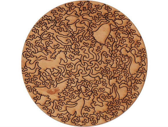 The Tannenwald jigsaw puzzle by Klimt, produced by Liberty Puzzles, features intricate, swirling designs in a circular shape. The wooden pieces showcase various animals and nature-inspired motifs, making it an engaging and artistic puzzle.