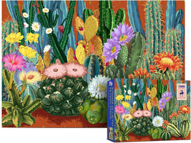A vibrant jigsaw puzzle titled 'Whisper of Cactus' featuring an intricate design of various cacti and desert flowers, showcasing bright colors like pink, yellow, and orange against a rich orange background. The colorful puzzle box is positioned beside the completed image, highlighting the artistic details of the cacti and the overall aesthetic appeal.