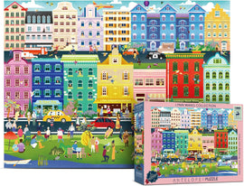The 'Amsterdam Weekend' jigsaw puzzle by Antalope Puzzles features a vibrant and colorful illustration of a lively scene in Amsterdam. The image showcases whimsical buildings in various hues, bustling street activity, and people enjoying their day. The puzzle box displays the title and contains 1000 pieces, inviting puzzlers to engage in a fun and rewarding experience.
