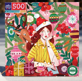 A vibrant jigsaw puzzle box featuring Ms. Santa with a reindeer. The design includes colorful Christmas ornaments, flowers, and gifts, creating a festive atmosphere. This 500-piece puzzle is made by Eeboo and highlights joyful holiday imagery.