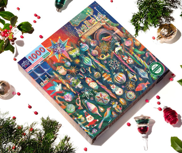 Eeboo Holiday Ornaments jigsaw puzzle featuring a colorful assortment of festive ornaments including stars, trees, and playful holiday characters. The box shows vibrant artwork with various designs, suitable for puzzle lovers and holiday enthusiasts. Contains 1000 pieces, perfect for family gatherings and seasonal fun.