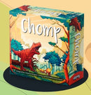 Chomp game by Allplay featuring vibrant artwork of a T-Rex in a prehistoric forest setting. The box showcases the game's title prominently along with colorful illustrations that capture the playful theme.