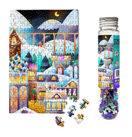 Micro Puzzle Alpine Village 150-piece jigsaw puzzle featuring vibrant illustrations of a winter village with snow-capped mountains and charming houses. The puzzle is displayed next to a bottle containing loose pieces, ready to be assembled for a fun and engaging activity.