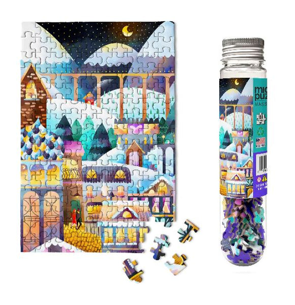 Micro Puzzle Alpine Village 150-piece jigsaw puzzle featuring vibrant illustrations of a winter village with snow-capped mountains and charming houses. The puzzle is displayed next to a bottle containing loose pieces, ready to be assembled for a fun and engaging activity.
