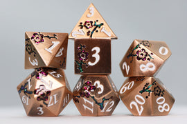 A beautiful set of copper-hued dice featuring intricate floral designs. The dice include a D20, D12, D10, D8, D6, and D4, showcasing elegant white numbers against a shimmering copper background.