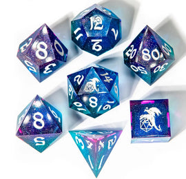 A stunning Fairy Stone Sharp Edge Dice Set by Hymgho featuring seven uniquely designed dice in deep blue and purple speckled with glitter. The set includes different types of polyhedral dice with clear white numbers, ideal for tabletop gaming and RPG adventures.