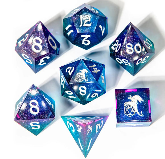 A stunning Fairy Stone Sharp Edge Dice Set by Hymgho featuring seven uniquely designed dice in deep blue and purple speckled with glitter. The set includes different types of polyhedral dice with clear white numbers, ideal for tabletop gaming and RPG adventures.