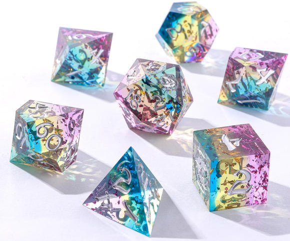 A colorful RPG dice set from Hymgho, featuring sharp-edged dice in various geometric shapes. The set includes a d20, d12, d10, d8, d6, and d4, all with translucent, rainbow-infused resin and silver numbers for easy reading.