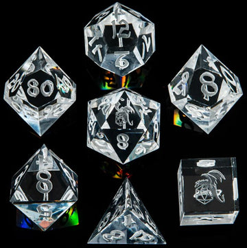 A set of eight white crystal sharp edge dice by Hymgho, including various shapes such as d4, d6, d8, d10, d12, and d20. Each die features clear, engraved numbers and symbols for easy reading, displayed on a dark reflective surface.