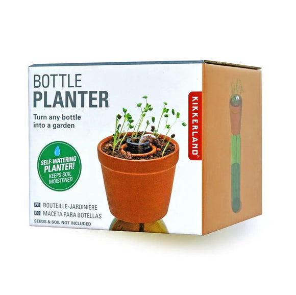 Kikkerland Bottle Planter packaging showcasing a self-watering planter that turns any bottle into a garden. The box has a clay pot with sprouts and highlights features like keeping soil moist. Seeds and soil not included.