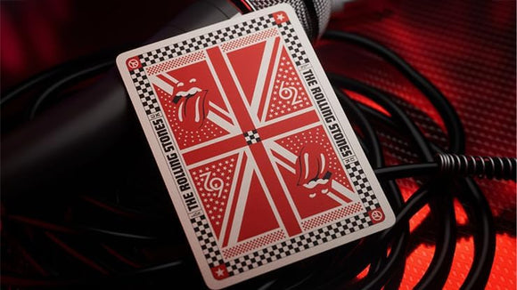 A detailed image of a Rolling Stones playing card featuring the iconic band logo and British flag motif. The card is positioned on top of a black microphone cable, with a visually striking red and black background that enhances the rock-and-roll vibe.