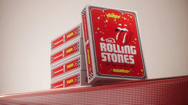 A stack of Rolling Stones Playing Cards by Theory 11 with vibrant red packaging featuring the iconic tongue logo and stars, perfect for fans and card game enthusiasts.