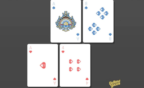 A set of Bicycle Little Atlantis Day Playing Cards featuring a blue Ace of Spades with intricate design, an 8 of Spades adorned with fish patterns, and red Aces and a 4 of Hearts. The cards are displayed on a dark background, highlighting their unique artwork and detail.